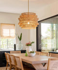 17.3" 17.3 Inch Rattan Pendant Light, Boho Wicker Chandelier for Dining above a wooden dining table in a bright room.
