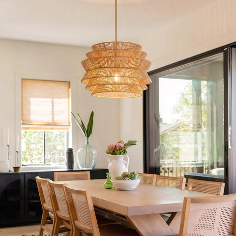 17.3" 17.3 Inch Rattan Pendant Light, Boho Wicker Chandelier for Dining above a wooden dining table in a bright room.