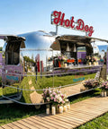 Slick Stainless Steel Food Trailer, 10 Ft Mobile Catering Cart With Mirror Finish, set up in a lavender field with flowers.