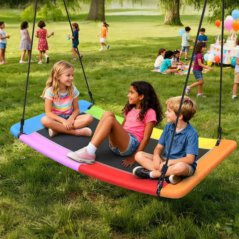 Children sitting on 700 Pound Capacity Giant 60 Inch Skycurve Platform Tree Swing For Kids And Adults With Two Hanging Straps Rainbow Patented Design