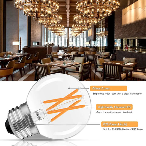 G16.5 LED globe bulb with clear filament details, shown in elegant chandelier-lit dining area with wooden decor.