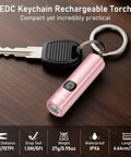 EDC Rechargeable Keychain Flashlight 360 Lumen Mini Pocket Light next to key on wooden surface