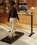 Person using Rock Solid Sit Stand Desk 48 By 24 Inch One Piece Rustic Top Black Frame Electric Height Adjustable Workstation.
