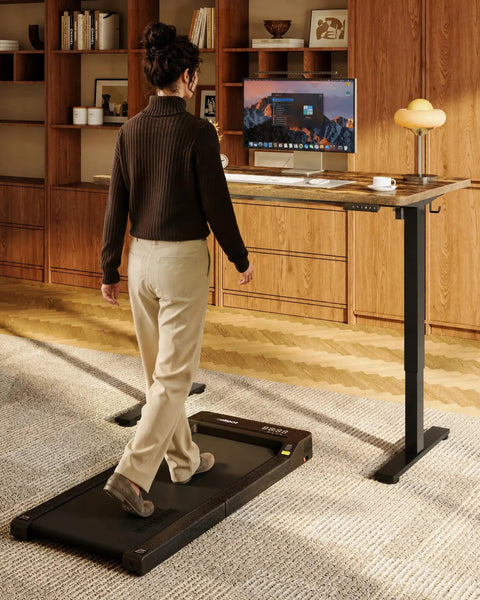 Person using Rock Solid Sit Stand Desk 48 By 24 Inch One Piece Rustic Top Black Frame Electric Height Adjustable Workstation.