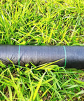 17 Inch Wide By 50 Feet Long Heavy Duty Landscape Fabric Weed Barrier Woven Geotextile Ground Cover roll on grass.