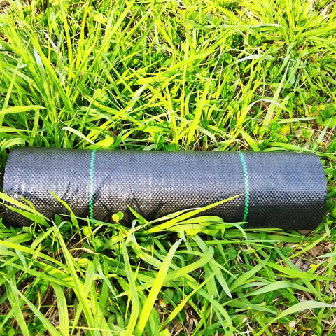 17 Inch Wide By 50 Feet Long Heavy Duty Landscape Fabric Weed Barrier Woven Geotextile Ground Cover roll on grass.