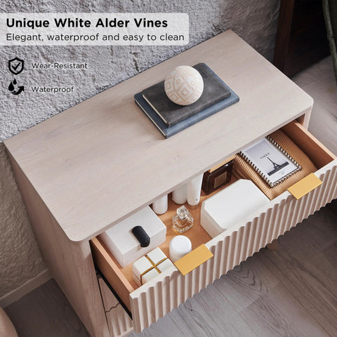 Set Of Two Fluted Nightstands Featuring Three Spacious Drawers And Clean White Alder Finish showing top view with various items and showcasing texture.