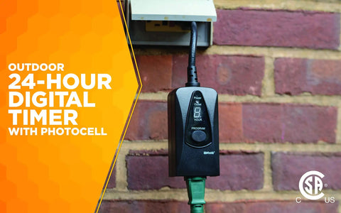 Outdoor Plug In Digital Timer With Weatherproof Housing Featuring Built In Photocell Light Sensor For Patio And Garden Illumination mounted on a wall.