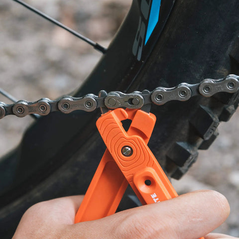 Using Bike Tire Levers With Chain Master Link Pliers Kit for Mountain Road BMX Bikes on bike chain, orange tool in action