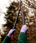 Woman pruning branches with Women Gardening Gloves With Micro Foam Palm Coating And Textured Grip For Weeding Digging Raking And Pruning.