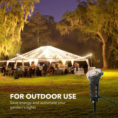 Heavy Duty Outdoor Power Stake Timer With Six Grounded Outlets And Six Foot Cord Weatherproof Mechanical Dial For Yard Lights And Garden Sprinklers 1875 Watt Capacity No Fuss Plug And Play in garden at night with lights.