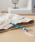 Fabric Loop Tube Turner Sewing Tool For DIY Crafting And Garment Making, Handy Threading Device For Hand Knitting And Craft Projects, Plastic And Metal Materials, Versatile Reliable Beginner Friendly Go To Helper used with white elastic in beige fabric tube