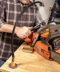 Man using IQ Connect Pro Grade Hands Free Accessory System with three bench mounts, magnifying glass, and work light on workbench