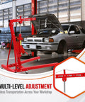 Heavy Duty 2 Ton Hydraulic Engine Hoist With Telescopic Boom And Six Smooth Roll Casters 4400 Pound, red crane lifting engine in workshop.