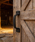 Heavy Duty Sliding Barn Door Handles Black 7 Inch Two Pack Rustic Gate Pull Handles for Shed Fence Cabinet Full Hand Grip Rust Resistant Carbon Steel Powder Coated installed on a barn door
