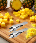 Stainless Steel Pineapple Eye Remover And Core Cutter With V Shaped Tip on cutting board with diced pineapples