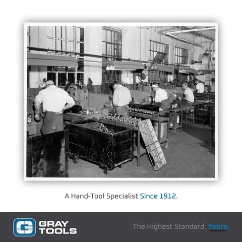 Vintage photo of workers in Gray Tools factory, hand-tool specialist since 1912, showcasing early manufacturing environment.