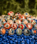 20 Piece Retro Look Flower Ceramic Cabinet Knob Set With Chrome Hardware For Cabinets And Drawers Hand Painted Multicolor Blue Creamy Red 42mm Diameter 30mm Bolt 30 To 55mm Knob Length displayed on colorful stones.