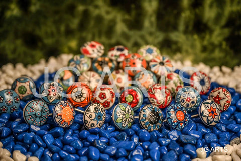20 Piece Retro Look Flower Ceramic Cabinet Knob Set With Chrome Hardware For Cabinets And Drawers Hand Painted Multicolor Blue Creamy Red 42mm Diameter 30mm Bolt 30 To 55mm Knob Length displayed on colorful stones.