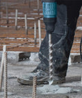 Worker using 3/4-Inch By 21-Inch SDS-Max Speed-X Rotary Hammer Bit with inclined side cutters for blazing concrete drilling