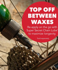 Close-up of a bicycle chain being lubricated with a green bottle, highlighting the message 'Top Off Between Waxes'.