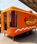 Kickstart Your Street Food Hustle With This Commercial Grade Mobile Food Truck Trailer featuring a bright orange exterior and hot dog graphic.