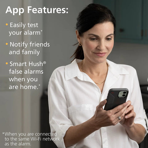 Woman interacting with smartphone app features for Top Shelf Smart Smoke Detector Delivering Wifi Connectivity Alexa Integration Hardwired Design With Battery Backup Voice And App Alerts Rock Solid Home Defense No Sweat Install Two Pack.