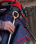 Hide Away Golf Ball Retriever with 18 Foot Reach in Bright Orange attached to golf bag, highlighting magnetic gripper head.
