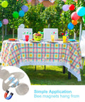 Outdoor table with checkered cloth secured by heavy duty stainless steel tablecloth clips; balloons in the background.