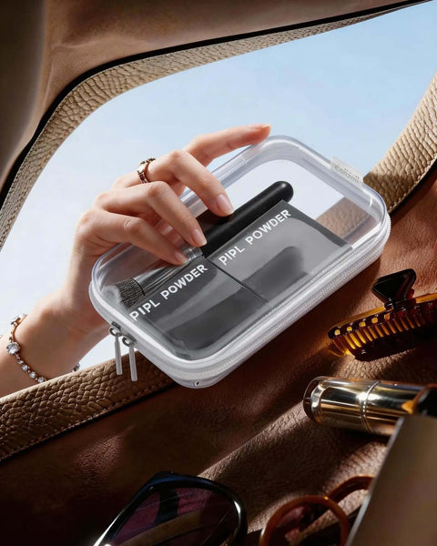 Large Translucent Dark Brown Hard Shell Zipper Case Featuring Hella Tough Drop Protection And Straight Up Scratch Resistance For Your Everyday Electronics With A Chill Clear Finish in hand beside a bag.