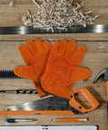 Full Leather Short Welding Gloves For Men on wooden workbench with tools, heat resistant, abrasion resistant, orange leather gloves