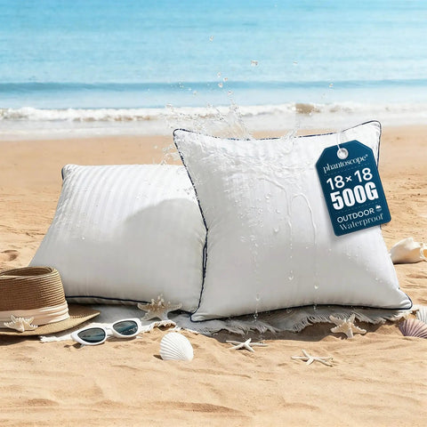 Outdoor Pillow Inserts 18x18 Inch Waterproof Striped With Reinforced Piping Pack Of 2 on a beach with water splashing on them.