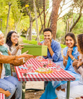Three Piece Fitted Picnic Table Cover Set With Bench Covers Vinyl Tablecloth With Flannel Backing For 6ft Tables Outdoor Camping Red Checked 30 By 72 Inches Water And Oil Resistant Elastic Edges For A Snug Stayput Fit used at a picnic with people.