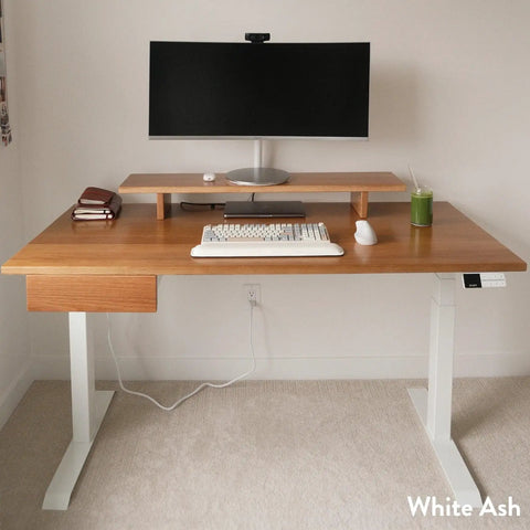 Heavy Duty Solid Hardwood Standing Desk With Seamless Under Desk Drawer And Effortless Adjustable Height Mechanism Featuring Real Walnut Surface And Matte Black Frame For A Sick Fresh Workstation Upgrade with monitor, keyboard, and mouse.