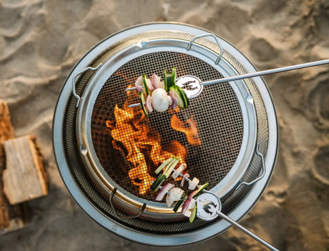 Bonfire Shield Spark Protector Mesh Screen For Fire Pits Durable Stainless Steel Guard in use with skewers over fire