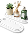 Natural Diatomite Water Absorbing Stone Tray Set Of Two showcased with plant, candle, and soap dispenser on countertop.