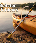 Compact Cordless Stick Water Transfer Pump For Outdoor Tank Draining And Emergency Fluid Removal near a kayak by water.