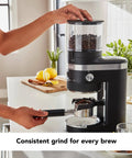 Person using Smart Dosing Burr Coffee Grinder KCG8433 Black Matte Delivers Consistent Grind Size For Every Brew From French Press To Espresso