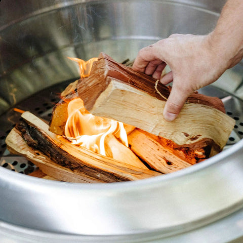 Juniper Aromatic Firewood For Outdoor Fire Pits And Backyard Fires Kiln Dried Logs Dope Natural Scent being placed in fire pit