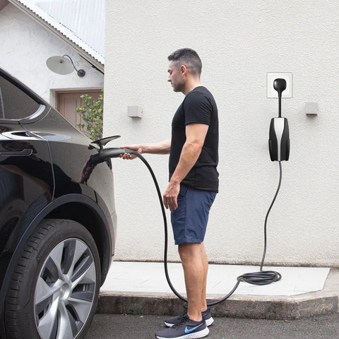 Man using Road Trip Ready Nema 14 To 50 Ev Charger Adapter For Tesla Gen 2 Mobile Unit 32 Amp Level 2, black extension cable.