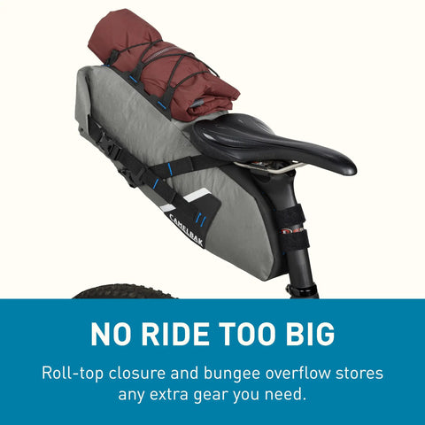 Mule 9 Bikepacking Rolltop Waterproof Saddle Bag For Tents And Gear With IPX5 Rating mounted on bike, carrying a rolled tent.