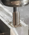 Precision 6-32 Plug Tap And No. 36 Drill Bit Combo Set For Right Hand Threads with tap engaged in metal block.