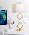 32-Inch Gold Iron Ogee Trellis Table Lamp With USB Port, Modern Glam Geometric Base, White Linen Rectangle Shade, LED Bulb Included, ETL Listed Lit Living Room And Bedroom Lighting next to a charging phone