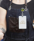 Heavy Duty Metal Badge Reel With 360 Degree Swivel And Secure Belt Clip attached to an apron, showcasing ID holder for staff use.