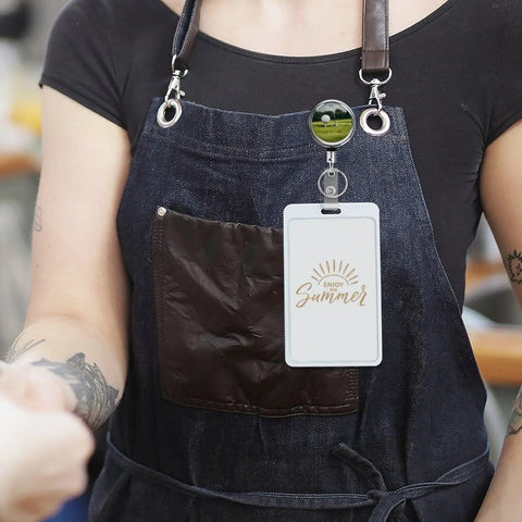 Heavy Duty Metal Badge Reel With 360 Degree Swivel And Secure Belt Clip attached to an apron, showcasing ID holder for staff use.