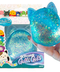Blue Gelli Gel Squishy Boasting Slow Flow Glitter And Iconic Shape Memory For Ultimate Stress Relief And Seriously Dope Fidget Fun That Hits Different Every Time You Play held in hand near its packaging.