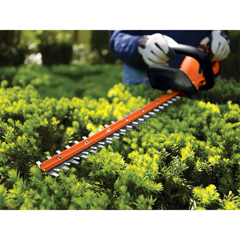 20V Max Cordless Hedge Trimmer With 22 Inch Dual-Action Steel Blade used on bushes in a garden