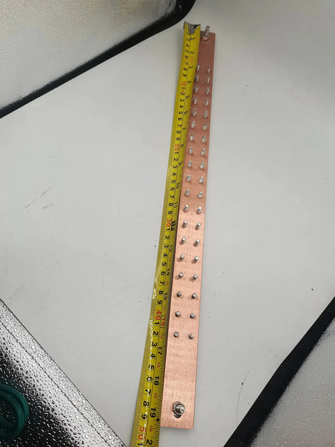 19 Inch Copper Ground Bus Bar Kit With 4 Foot Grounding Cable For Data Rack Cabinet Or Enclosure UL Listed C110 Copper Busbar Includes 38 Stainless Steel Screws And Mounting Hardware Ready To Install In Any 19 Inch Rack laid out with measuring tape
