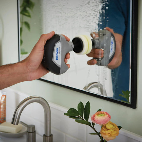 Person using Versa Power Scrubber Grout Brush And Shower Cleaning Tool For Tile Grout Sinks Stovetops Tubs Pans And Grills Grime Busting Compact Ergonomic Kitchen And Bath Cleaner For Auto Surfaces on bathroom mirror