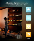 Person adjusting White And Color Ambiance LightStrip Plus Dimmable LED Smart Light 80 Inch on shelf for ambient lighting.